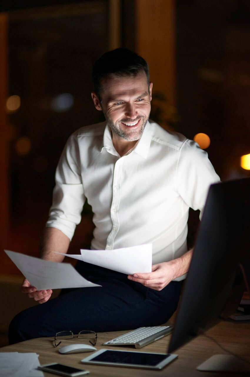 Man analyzing document at night