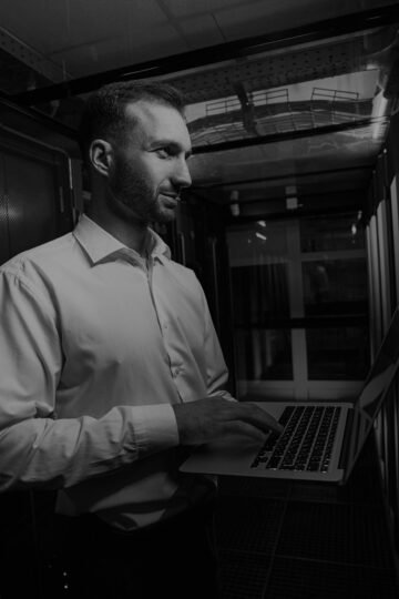 Portrait of handsome Caucasian maintenance administrator holding laptop in hands