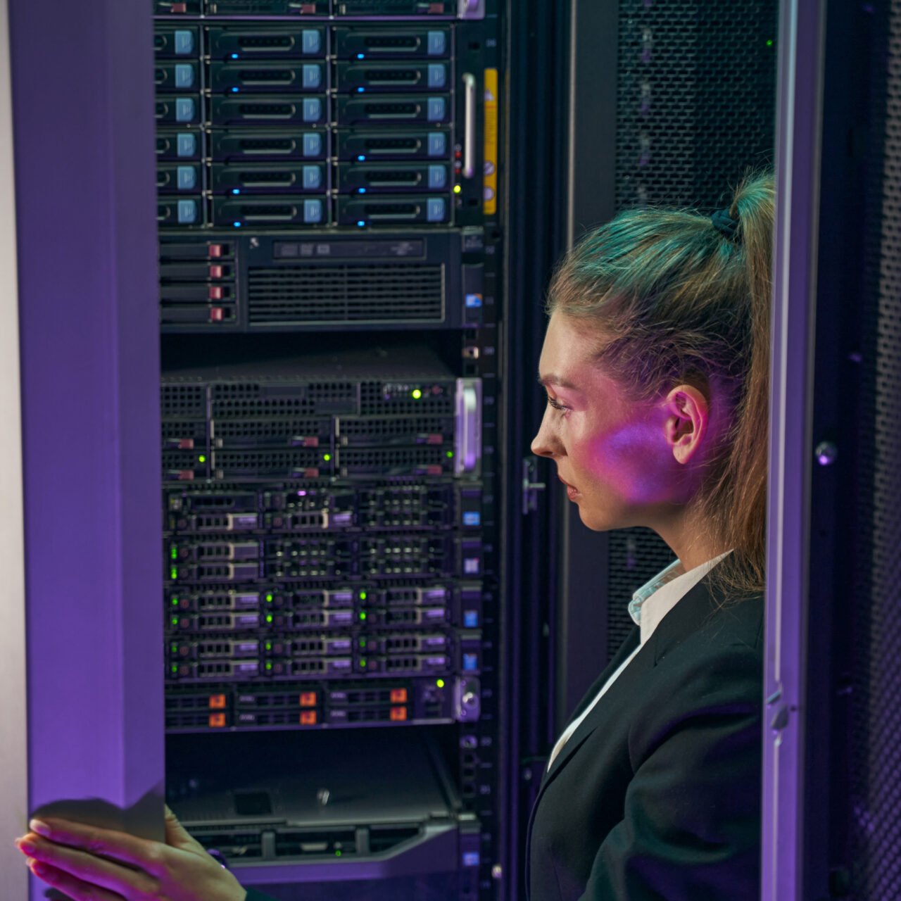 Female IT engineer solving problems and give help and support in network server room